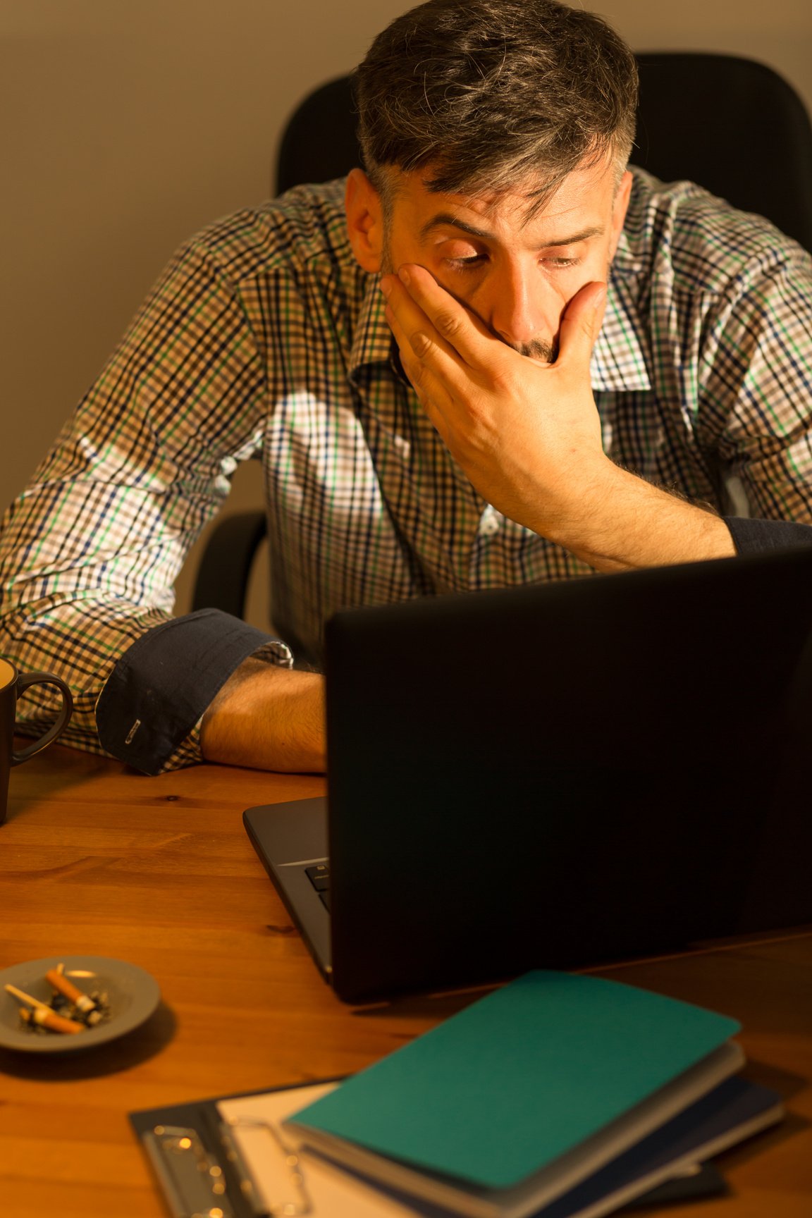 Tired male working on computer